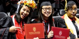 Chancellor's Scholars Cathryn Phouybanhdyt, left, and Joann Huynh show off their diploma covers during UW-Madison's winter commencement ceremony at the Kohl Center at the University of Wisconsin-Madison on Dec. 17, 2017. The indoor graduation was attended by more than 1,100 bachelor's and master's degree candidates, plus their guests. (Photo by Jeff Miller / UW-Madison)