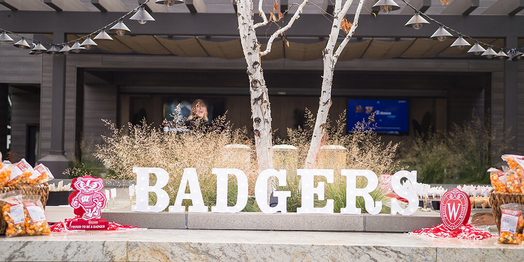 The word "BADGERS" lights up the Buckingham Club's rooftop gathering.