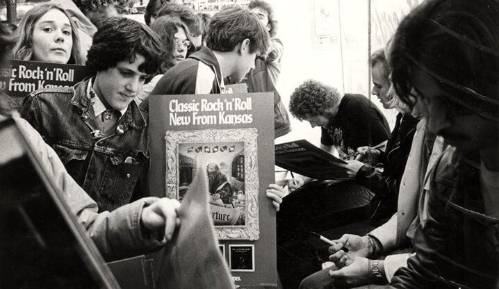 Students signing signs for "Classic Rock 'n' Roll.