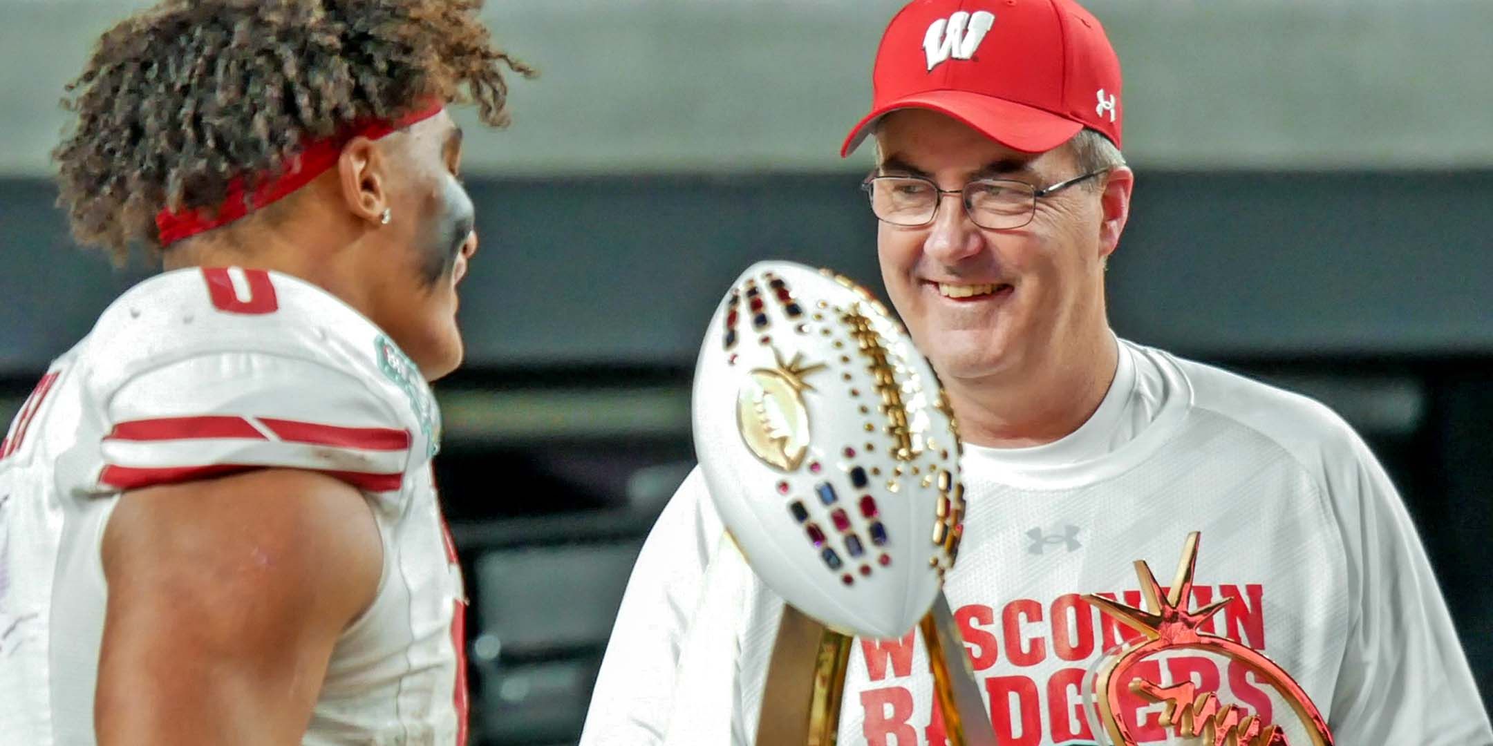 Paul Chryst and a Badger Football player celbrating the win of the Las Vegas Bowl
