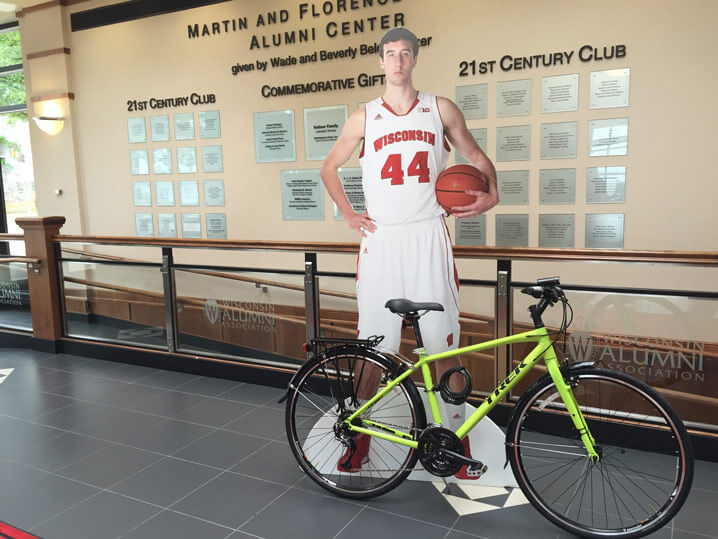 Cut-out of Frank Kaminsky near a bike.