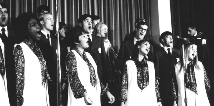 Black and white photo of group singing.