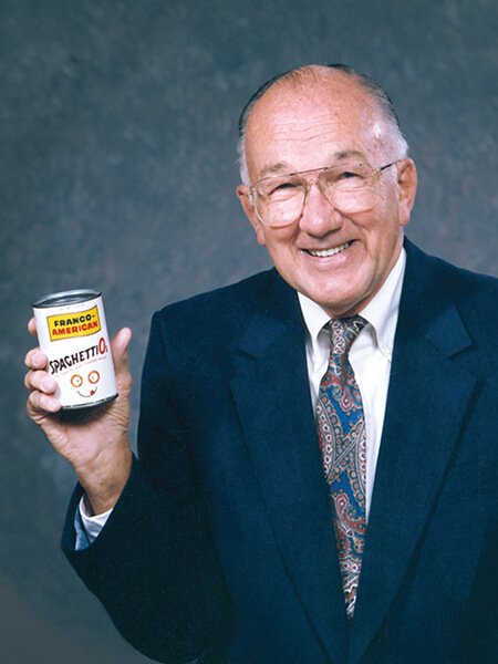 Donald Goerke MBA’51 holding a can of his creation "SpaghettiOs"
