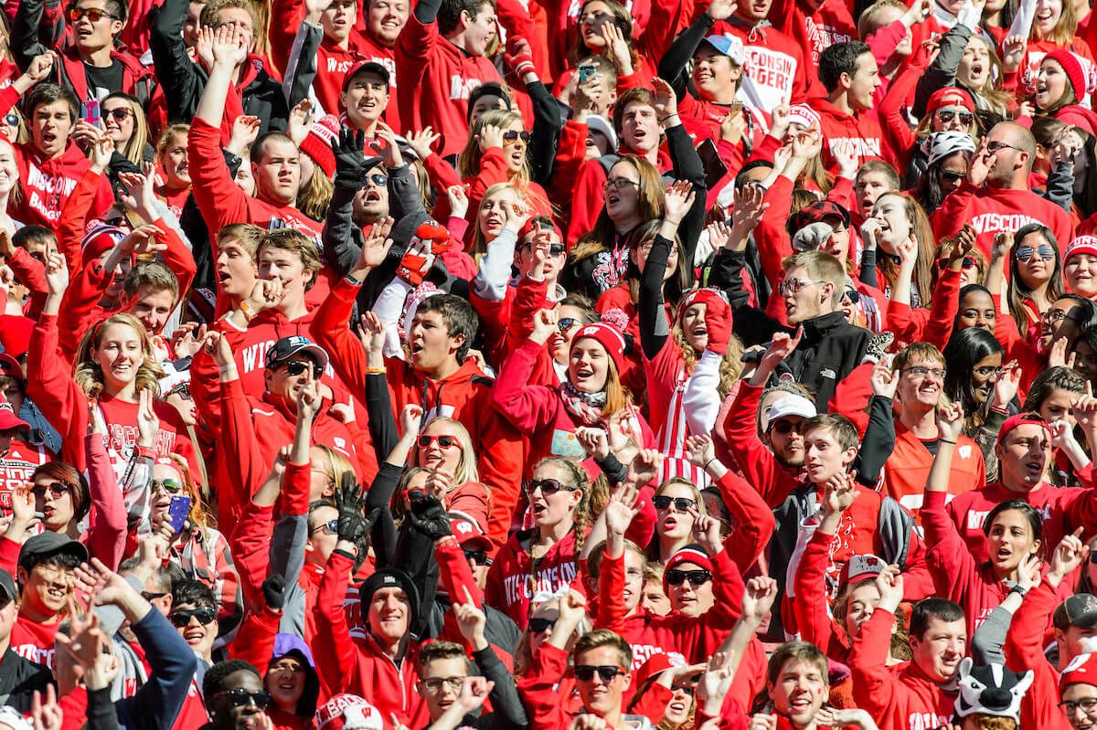 students jumping around at camp randall