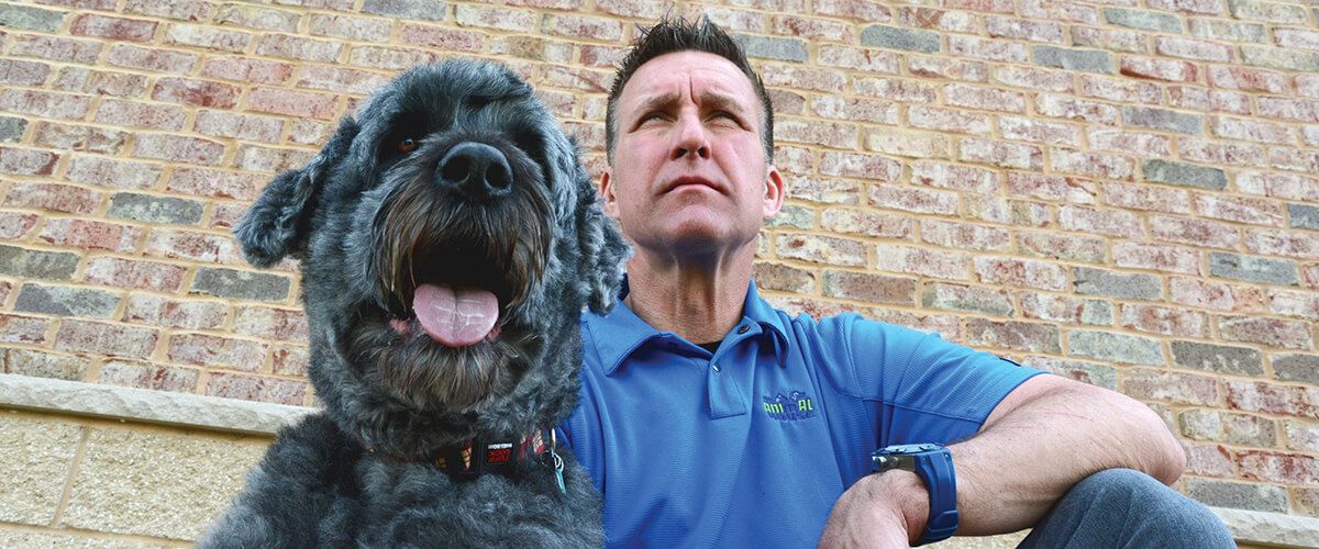 Veterinarian Patrick Warpinski (left) and dog