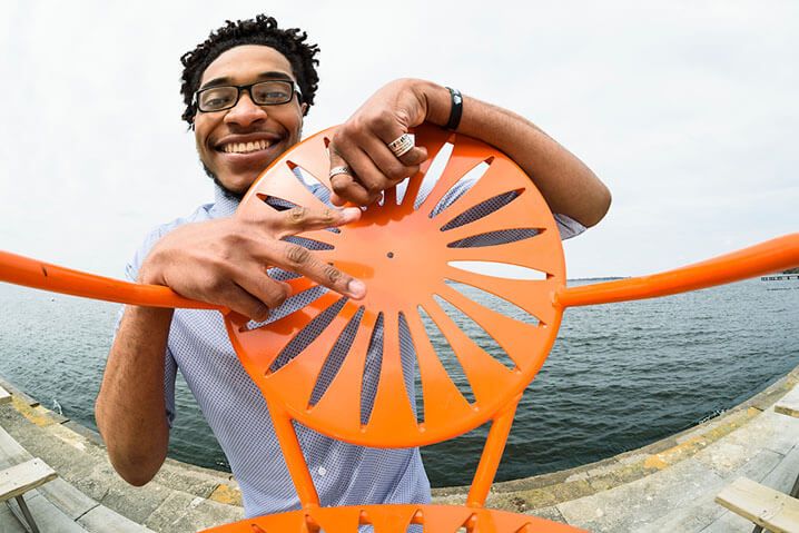 Deshawn McKinney ’17 carries a chair out to the Terrace, 2017.