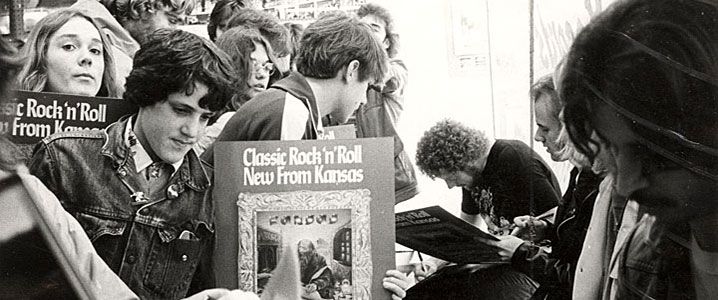 Students meeting rock 'n' roll band in 1970s.