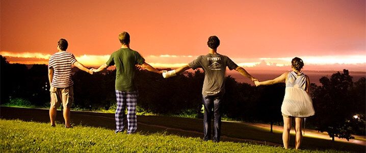 Group of 4 UW students enjoying a thunderstorm sunset.