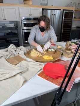 Christy McKenzie arranges various meats and cheeses