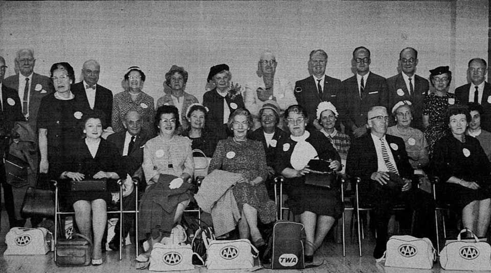 These Badgers were members of the pioneering 1963 Wisconsin Alumni Association tour of Europe. Seated, from left: Mrs. Rod A. Porter, Theron Woolson, Miss Muriel Henry, Mrs. Theron Woolson, Mrs. Arvilla Henry, Mrs. Harold J. Kelley, Mrs. D. W. Reynolds, Mrs. Daryal A. Myse, John Linden, Mrs. E. H. Gibson, Mrs. John Linden, Miss Mary Ann Merner. Standing, from left: Dr. Orrin Andrus, Oscar Kuentz, Mrs. Orrin Andrus, Charles F. Puls, Jr., Miss Kate Huber, Mrs. John MacNeish, Mrs. Oscar Kuentz, Don Reynolds, Daryal A. Myse, James Heller, Norman Gauerke, Mrs. Norman Gauerke, E. H. Gibson. Missing at the time of the picture: Miss Leora Ellsworth, Mr. and Mrs. Hubert Henrich.